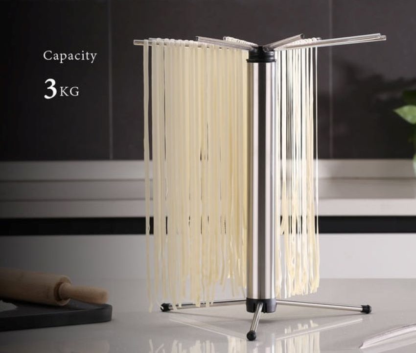 Homemade pasta drying on a foldable pasta drying rack.