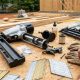 Professional Atlanta builder using a pneumatic framing nail gun on a residential construction site during summer