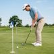 beginner male golfer using mallet putter on green