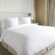 Cozy queen bed featuring soft, long-lasting sheets and a matching comforter set.