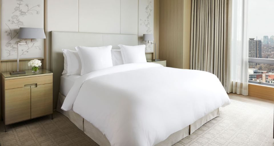 Cozy queen bed featuring soft, long-lasting sheets and a matching comforter set.