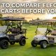 Two different electric golf carts parked side by side on a green fairway.