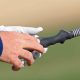 Close-up of golf club with alignment aid for grip correction