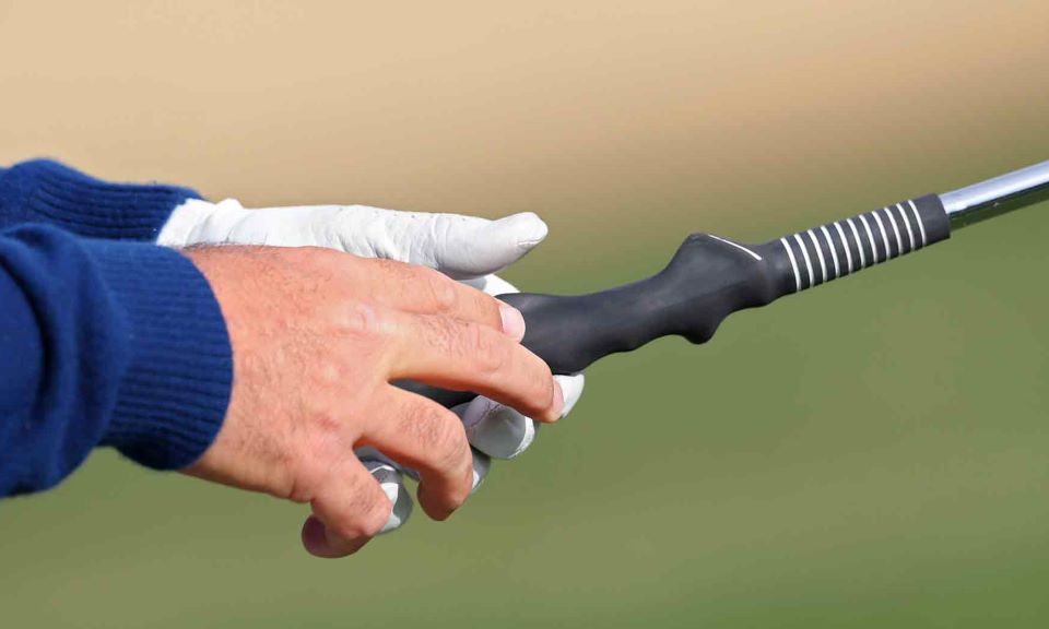 Close-up of golf club with alignment aid for grip correction