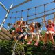 Child climbing rope ladder in a home backyard play set