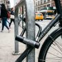 A heavy-duty U-lock securing a bicycle to a city bike rack.