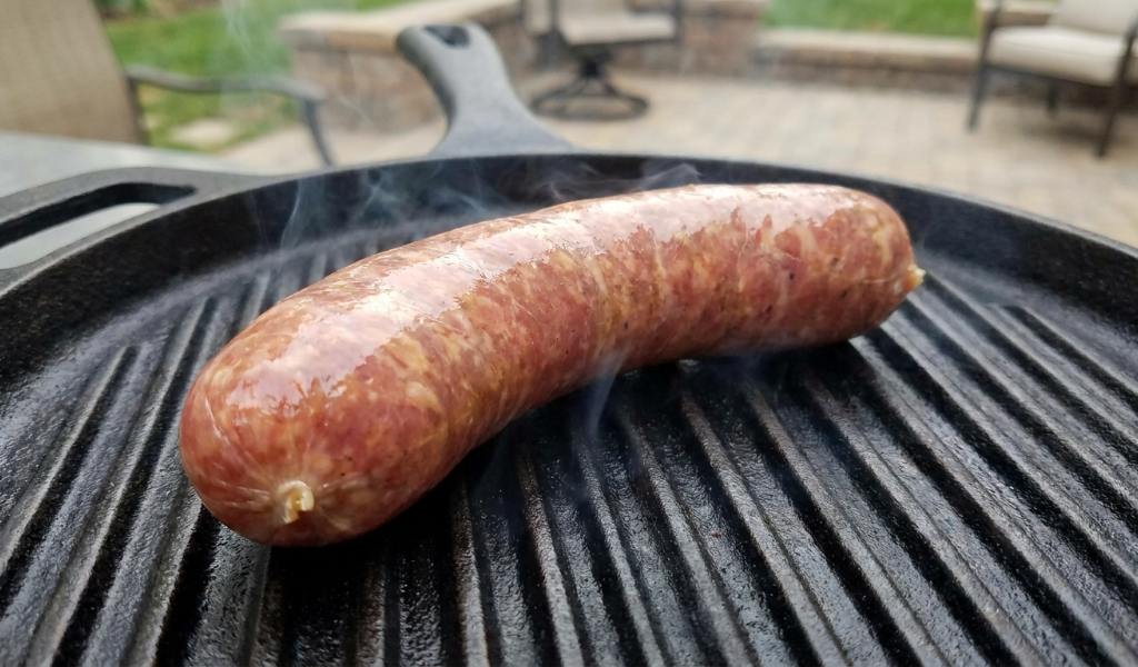 Searing unbroken Italian sausage links in seasoned cast iron pan